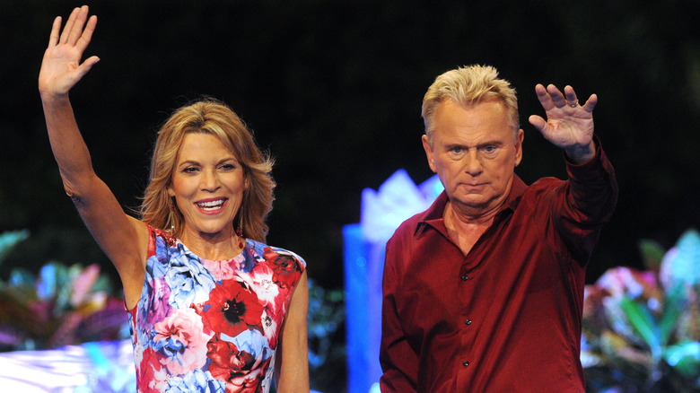 Vanna White and Pat Sajak waving