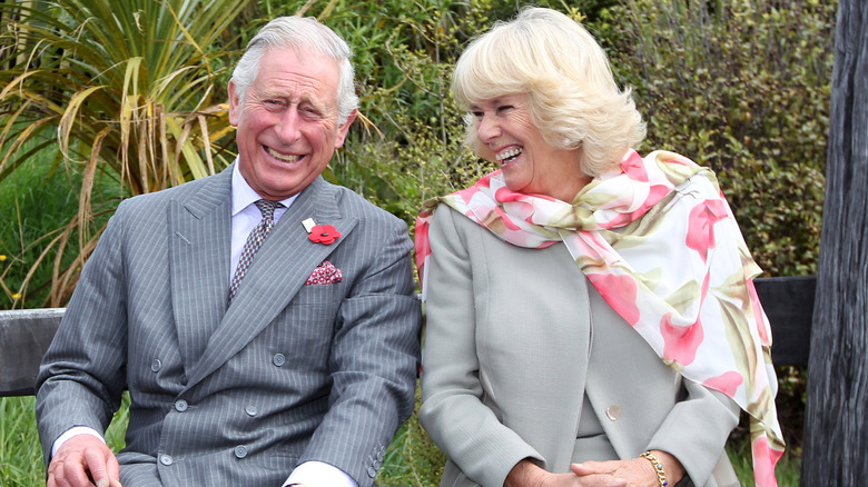 Prince Charles and Camilla Parker Bowles sitting laughing 