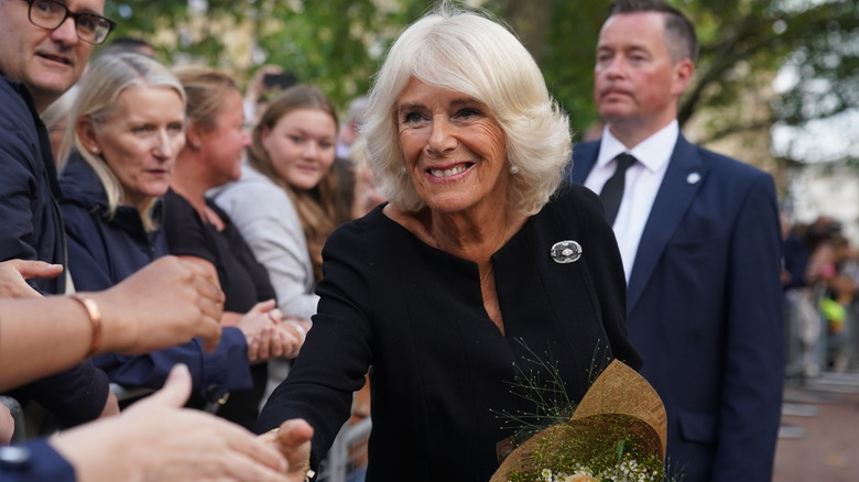 Queen Camilla greets mourners