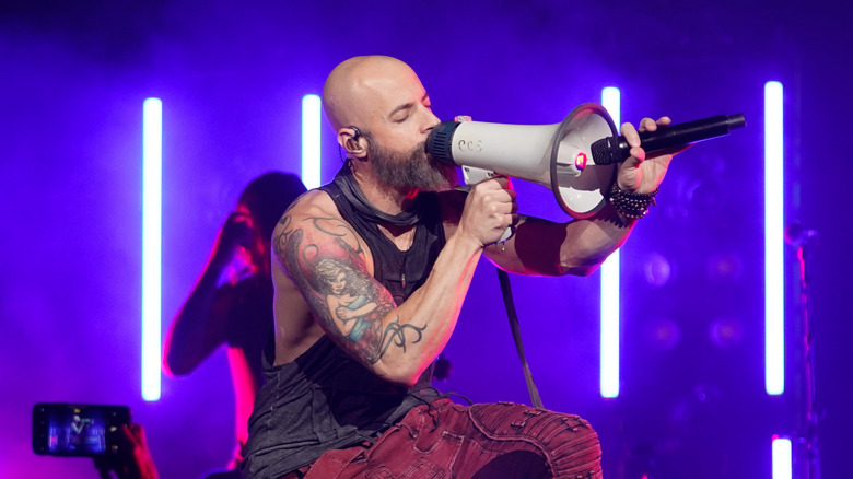 Chris Daughtry performing on stage with a megaphone