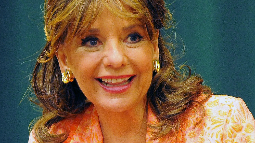 Dawn Wells holding her book at a book signing