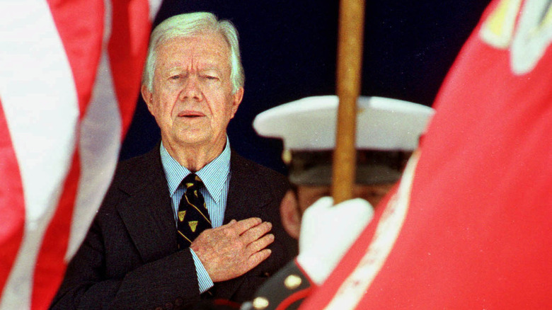 Jimmy Carter hand over heart during military honor