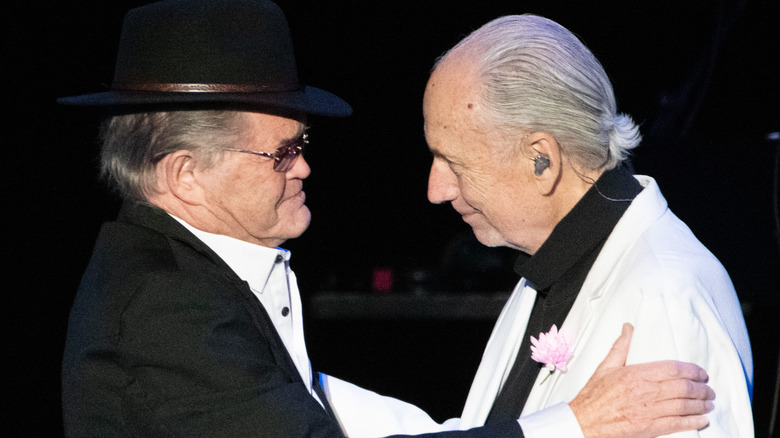 Micky Dolenz and Michael Nesmith hug