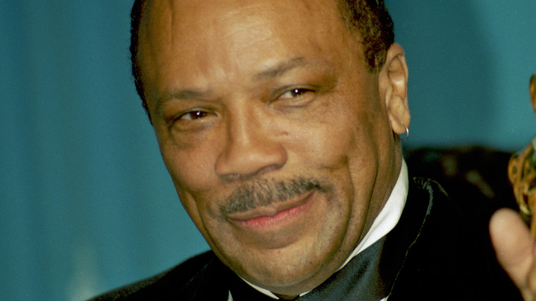 Quincy Jones waving on a red carpet