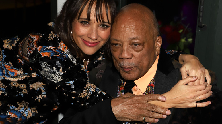 Quincy and Rashida Jones cuddling up at an event