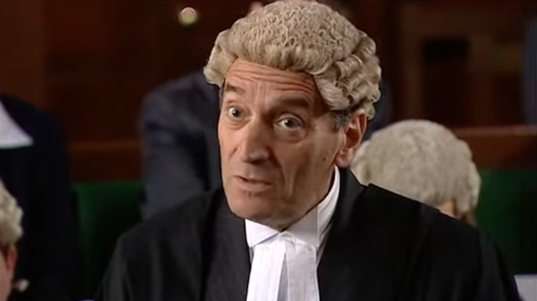 Stephen Greif wearing a barrister wig in an acting scene