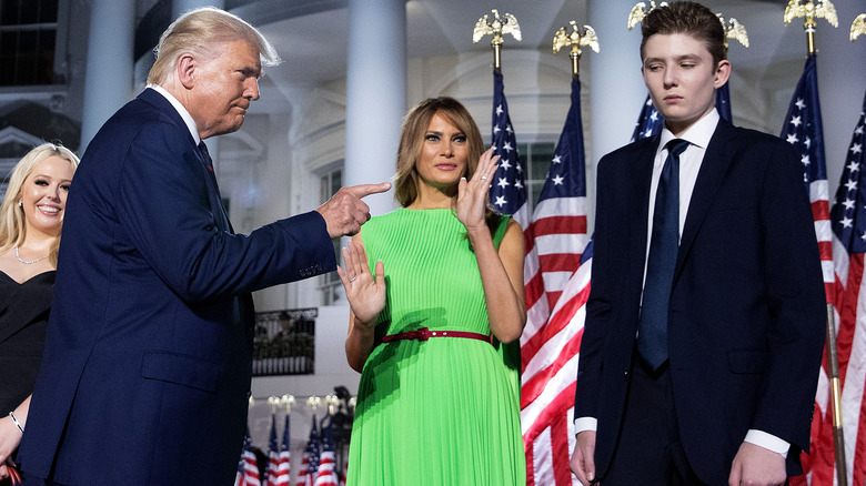 Donald Trump pointing at Barron in front of White House Melania claps