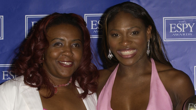 Serena Williams (R) poses her oldest sister Yetunde Price and her "Best Female Athlete" award backstage during the 2003 ESPY Awards