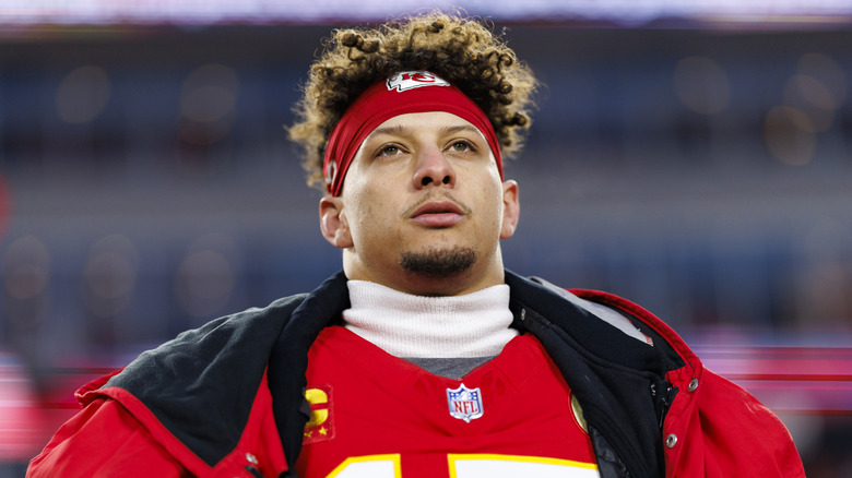 Patrick Mahomes wearing Chiefs gear and staring upward