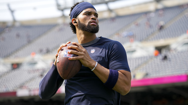 Caleb Williams holding football with painted fingernails visible