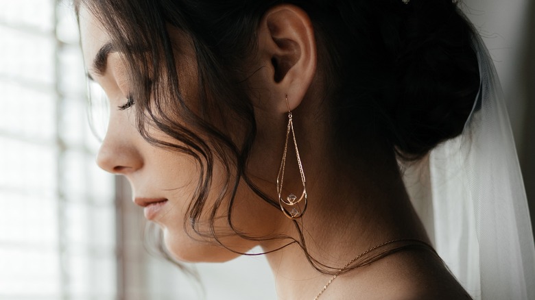 brunette woman wearing gold earrings