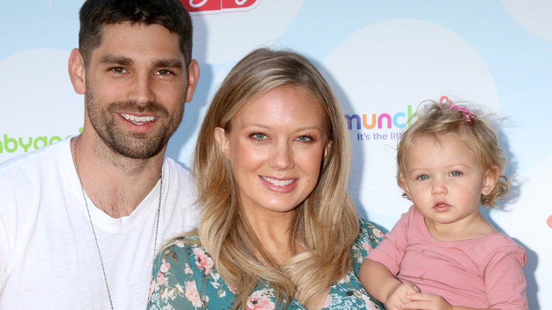 Justin Gaston and Melissa Ordway posing with baby Olivia in 2017