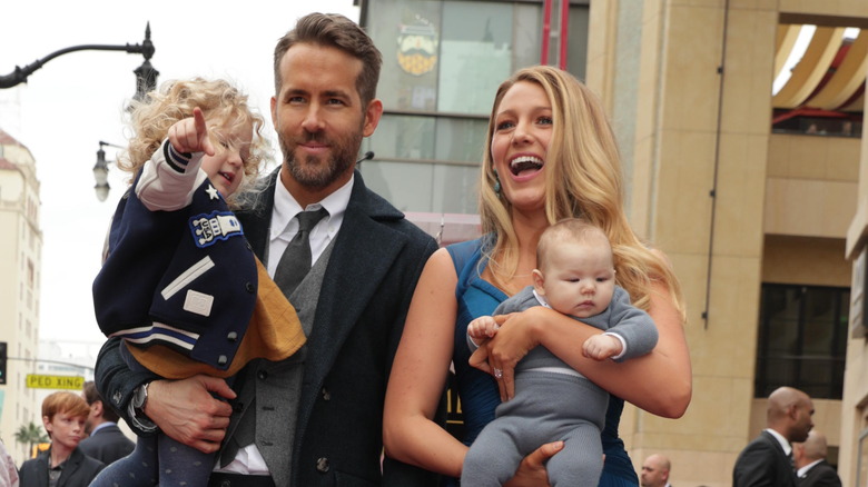 Ryan Reynolds and Blake Lively holding two of their daughters