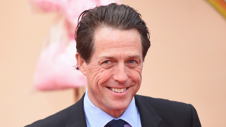 Hugh Grant smiles cheekily on the red carpet