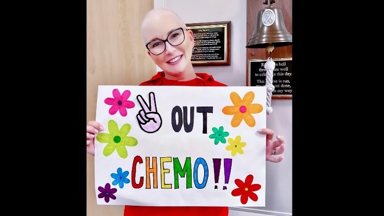 Clea Shearer holding sign celebrating the end of chemotherapy