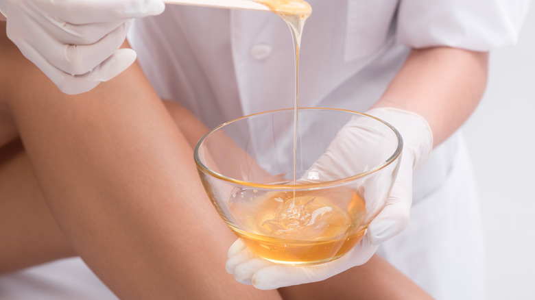 woman waxing her lower leg 