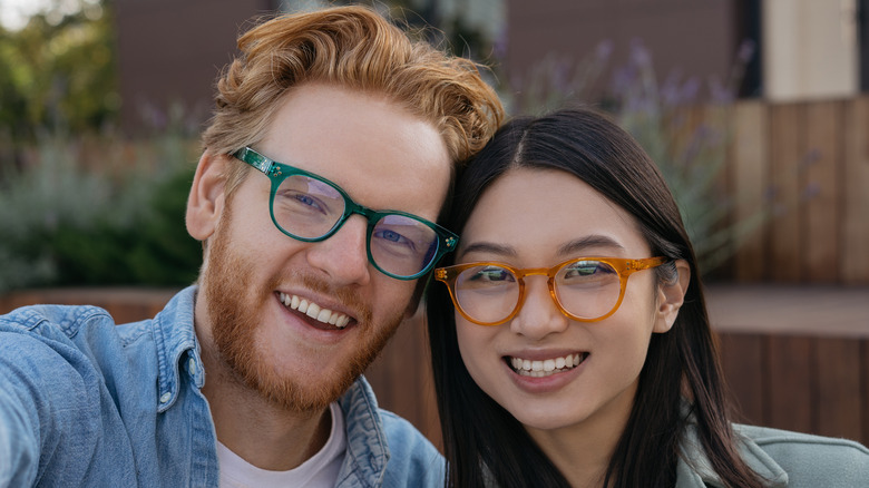 Couple wearing colorful glasses