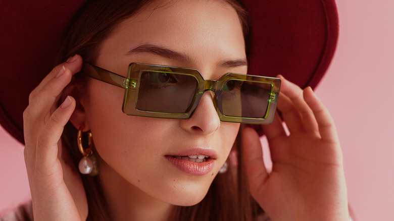 Model wearing green rectangular frames