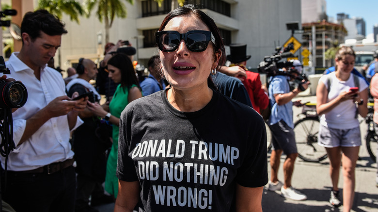 Laura Loomer outside in crowd wearing t-shirt reading 'Donald Trump did nothing wrong!'