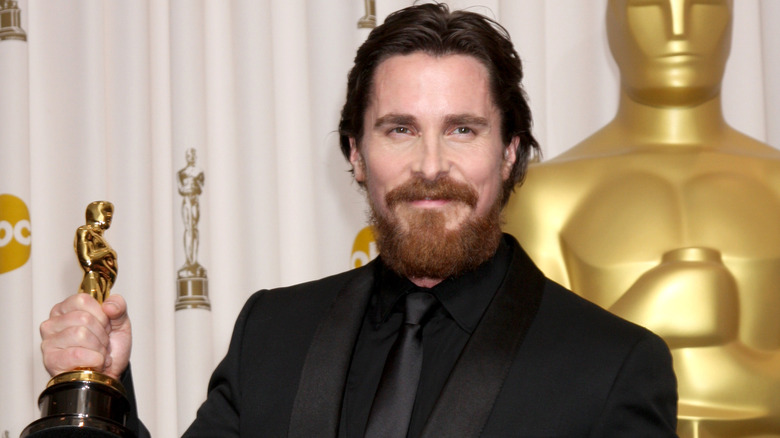 Christian Bale poses with an Oscar