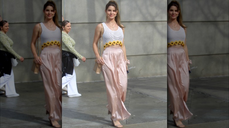 Amanda Cerny wearing a crop top and wide leg pants