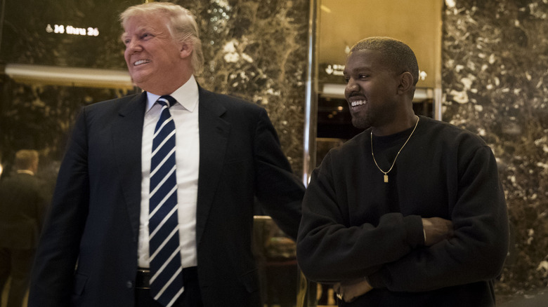 Donald Trump and Kanye West smiling at Trump Tower