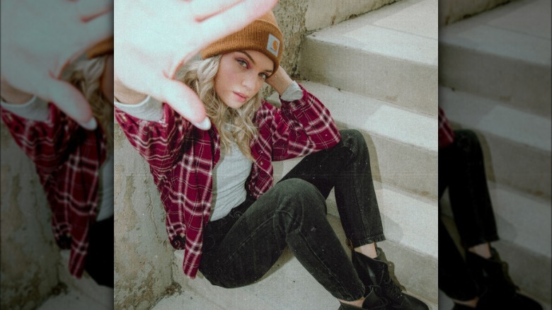 Blond posing in a red plaid flannel