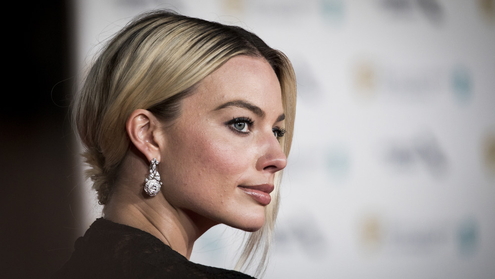 Margot Robbie with hair up, side profile