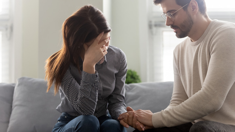 Couple holding hand during argument 