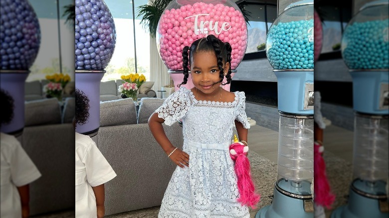 True Thompson standing in front of personalized gumball machine