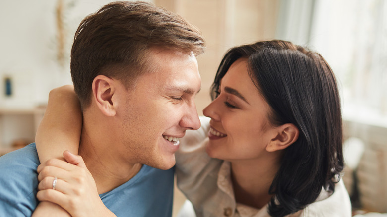 happy couple sitting on couch