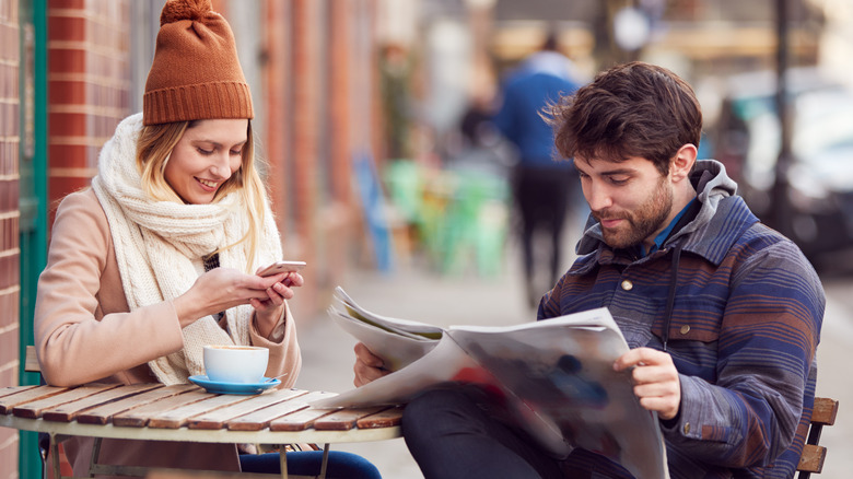 smiling couple outdoor coffee shop