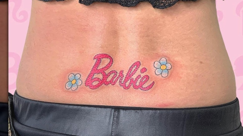 Barbie logo lower back tattoo