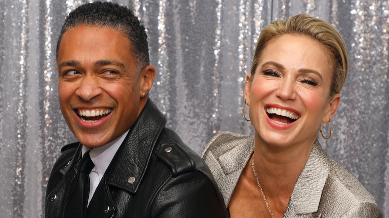 Amy Robach and T.J. Holmes laughing 