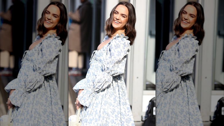 Bailee Madison smiling in a blue dress