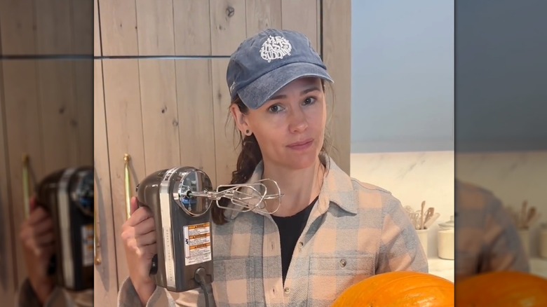 Jennifer Garner holding whisk in kitchen