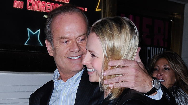 Kelsey Grammer smiling at his wife Kayte Walsh as they walk together