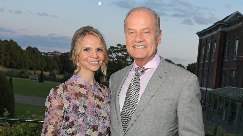 Kelsey Grammer and wife posing together outside