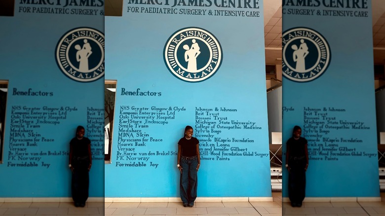 Mercy James posing in front of the Mercy James Centre