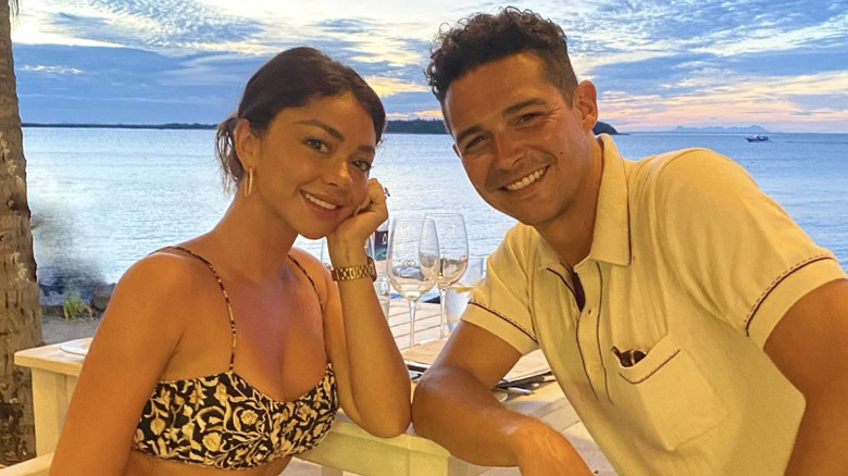 Sarah Hyland and Wells Adams posing together at dinner during vacation in Fiji