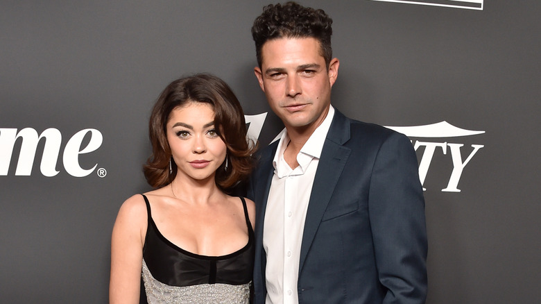 Sarah Hyland and Wells Adams posing on Variety step-and-repeat