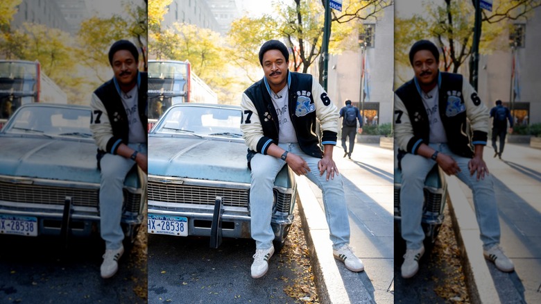 Craig Melvin sits atop a vintage car hood dressed as Beverly Hills cop