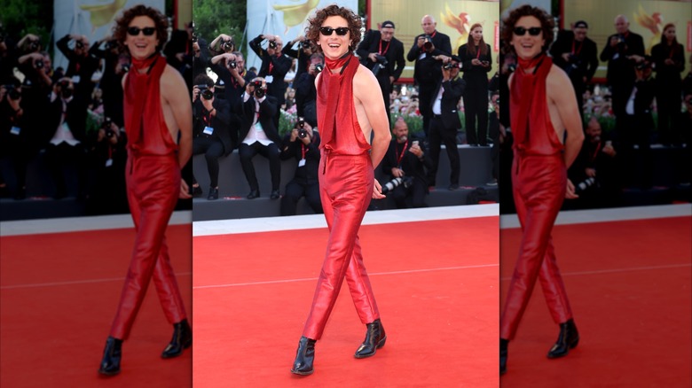 Timothee Chalmet on a red carpet in a red halter top and red pants