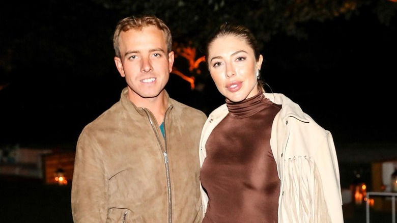 Hannah Selleck posing with Alex Hamer at a Hermès saddle event