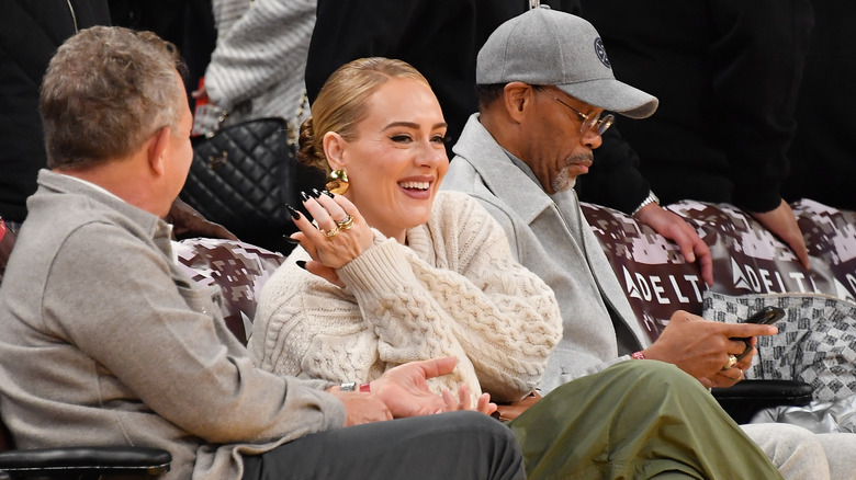 Adele sitting courtside