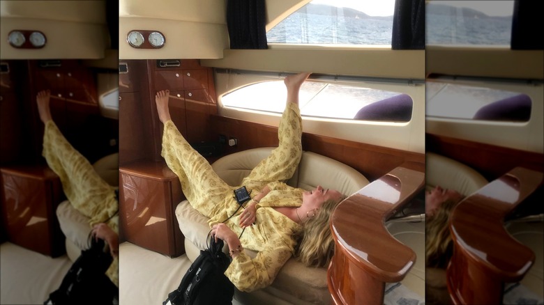 Adele relaxing on a boat in yellow loungewear