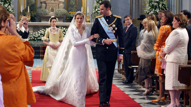 Queen Letizia and King Felipe walking down the aisle after getting married