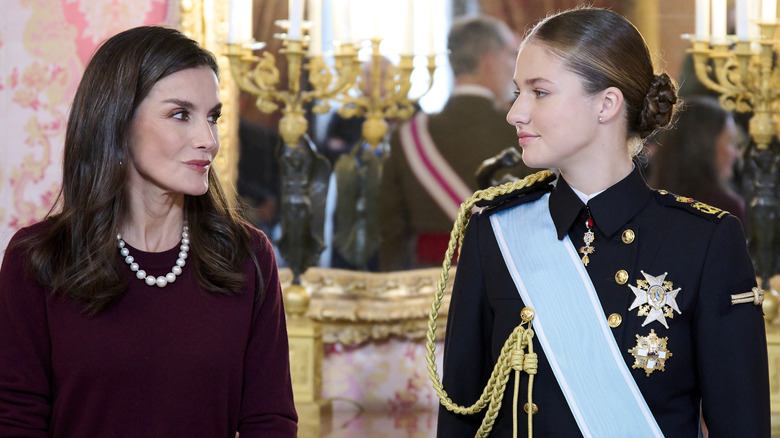 Queen Letizia looking at Princess Leonor in military uniform