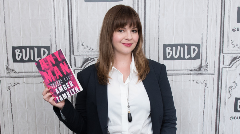 Amber Tamblyn holding her book "Any Man"