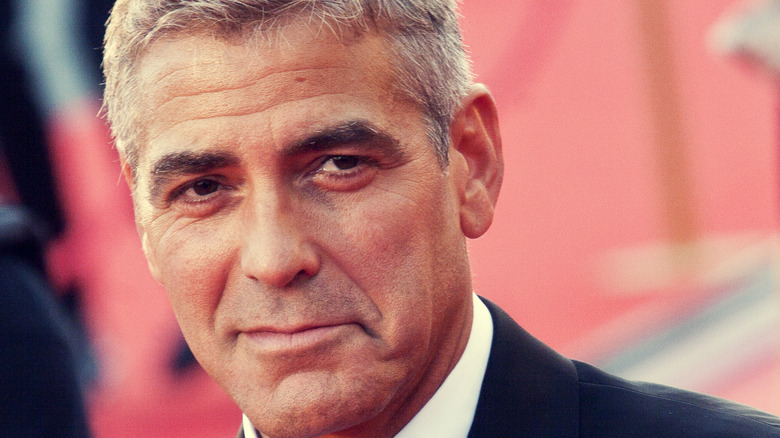 George Clooney smirking on red carpet